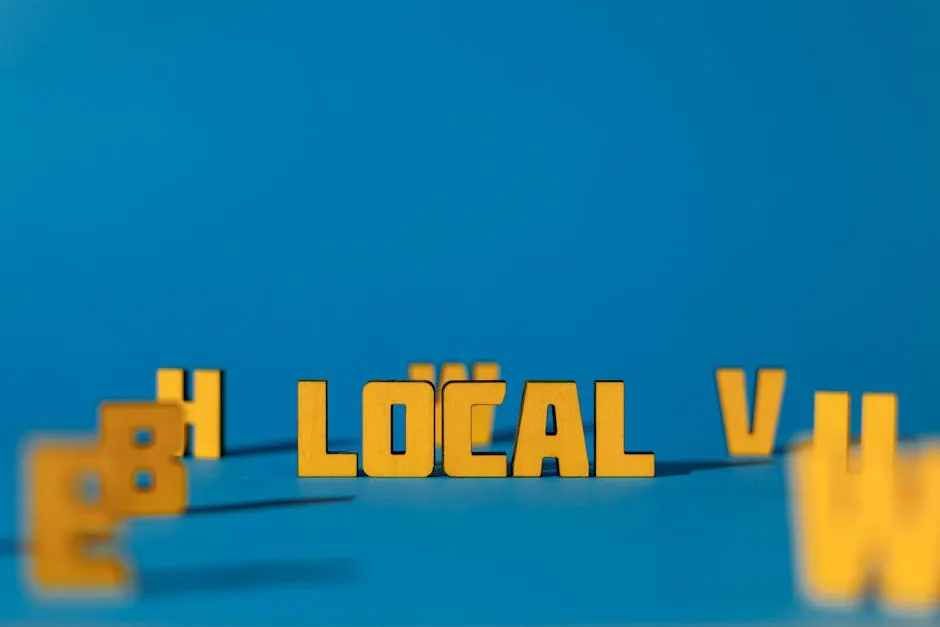 Abstract image featuring yellow wooden letters spelling 'LOCAL' on a blue background, offering ample copy space.