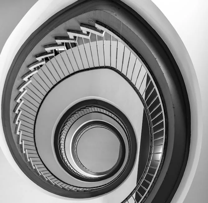 Dramatic black and white view of a spiral staircase in modern Hamburg architecture.